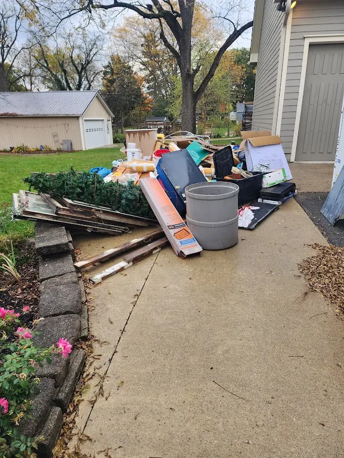 Dumpster being loaded with debris for Estate Cleanout Dumpster Rental in South Toms River